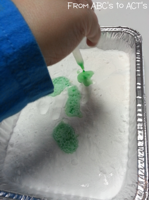 Using pipettes to combine baking soda and vinegar.