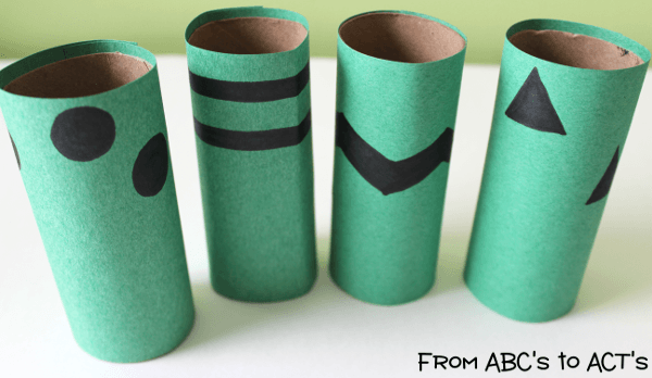 Cover your toilet paper rolls with your designed construction paper and glue them on.